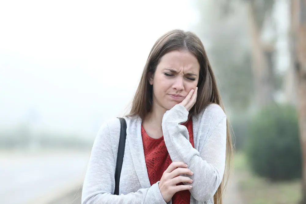 A woman with a toothache on the street.