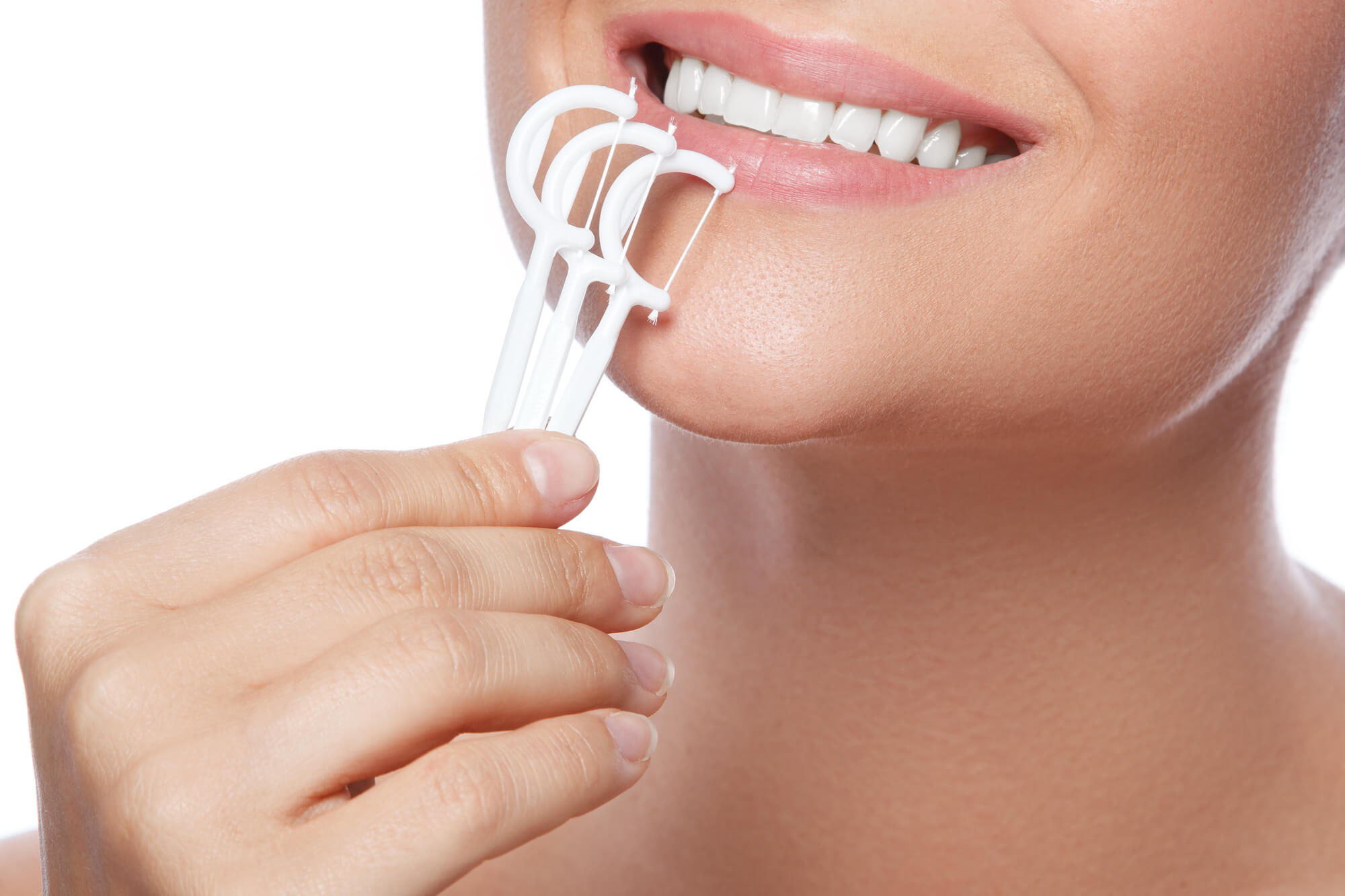 woman flossing her dental implants greenville sc